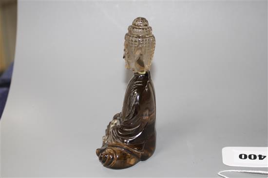 A Chinese smoky quartz seated figure of Guanyin, 19th/early 20th century, H. 11.5cm